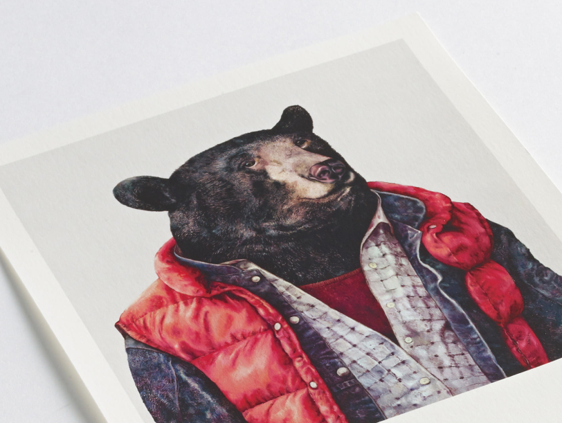 A print on paper with a black bear wearing a red gillet